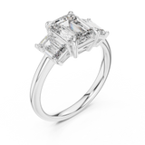 White gold lab grown diamond emerald cut three stone engagement ring, angled view