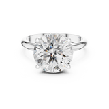 Front view of a round brilliant cut diamond solitaire engagement ring in white gold or platinum with a transparent background.