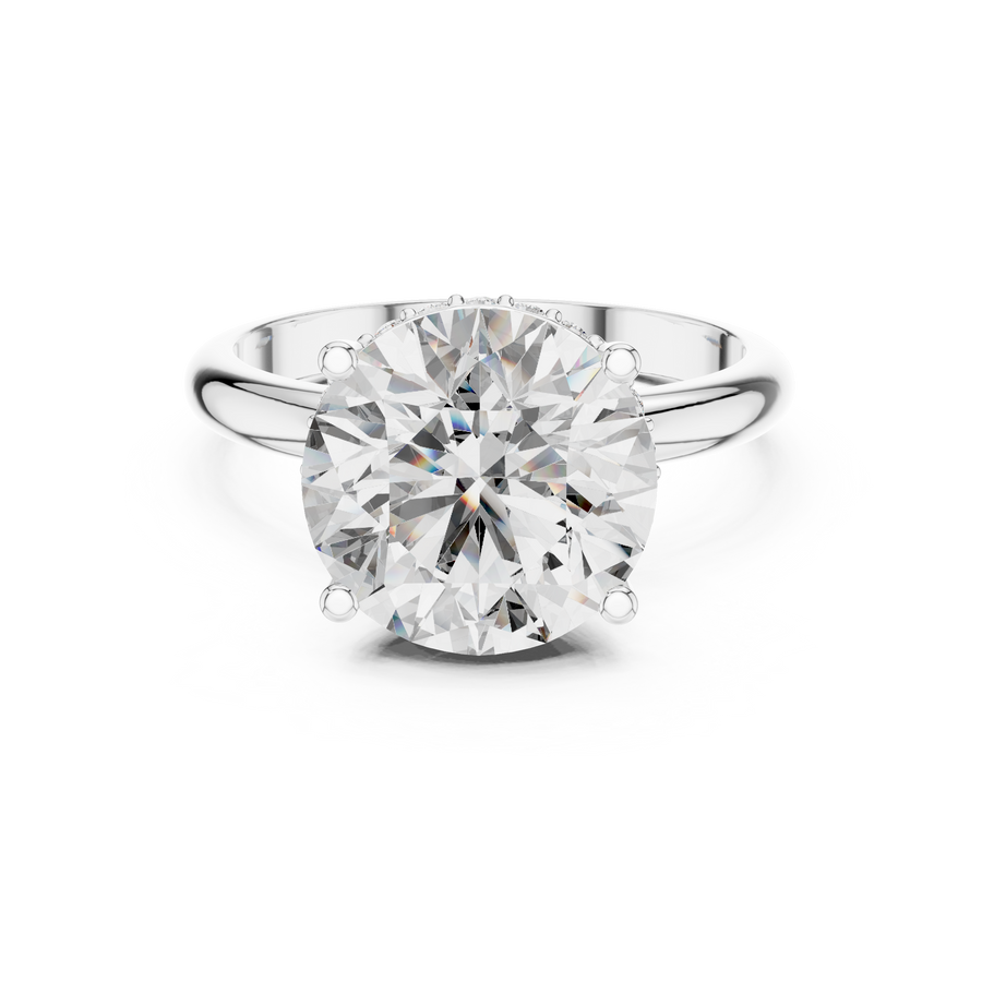 Front view of a round brilliant cut diamond solitaire engagement ring in white gold or platinum with a transparent background.