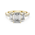 Yellow gold emerald cut three stone lab grown diamond ring, angled view