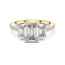 Yellow gold emerald cut three stone lab grown diamond ring, angled view