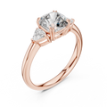 Rose gold lab grown diamond cushion cut three stone engagement ring, angled view