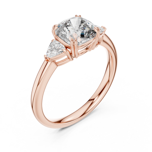 Rose gold lab grown diamond cushion cut three stone engagement ring, angled view