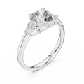 White gold lab grown diamond cushion cut three stone engagement ring, angled view