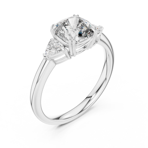 White gold lab grown diamond cushion cut three stone engagement ring, angled view