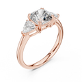 Rose gold lab grown diamond cushion cut three stone engagement ring, angled view