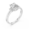 White gold lab grown diamond radiant cut three stone engagement ring, angled view