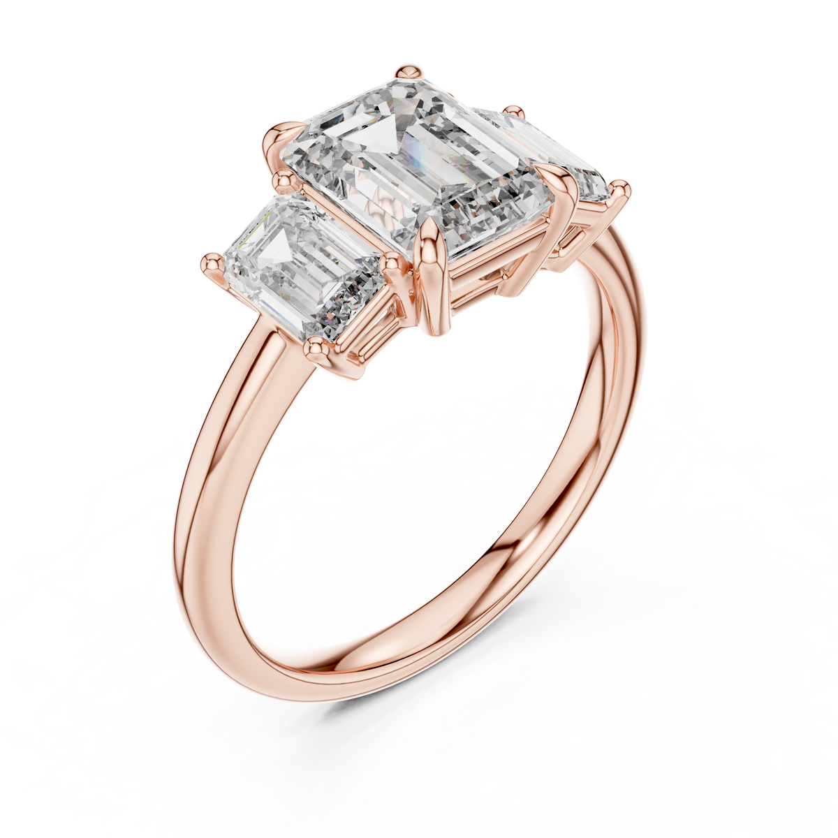 Rose gold lab grown diamond emerald cut three stone engagement ring, angled view