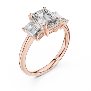 Rose gold lab grown diamond emerald cut three stone engagement ring, angled view