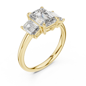 Yellow gold lab grown diamond emerald cut three stone engagement ring, angled view