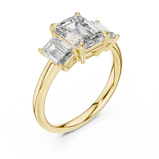 Yellow gold lab grown diamond emerald cut three stone engagement ring, angled view