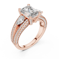 Rose gold lab grown diamond emerald and pear three stone engagement ring, angled view