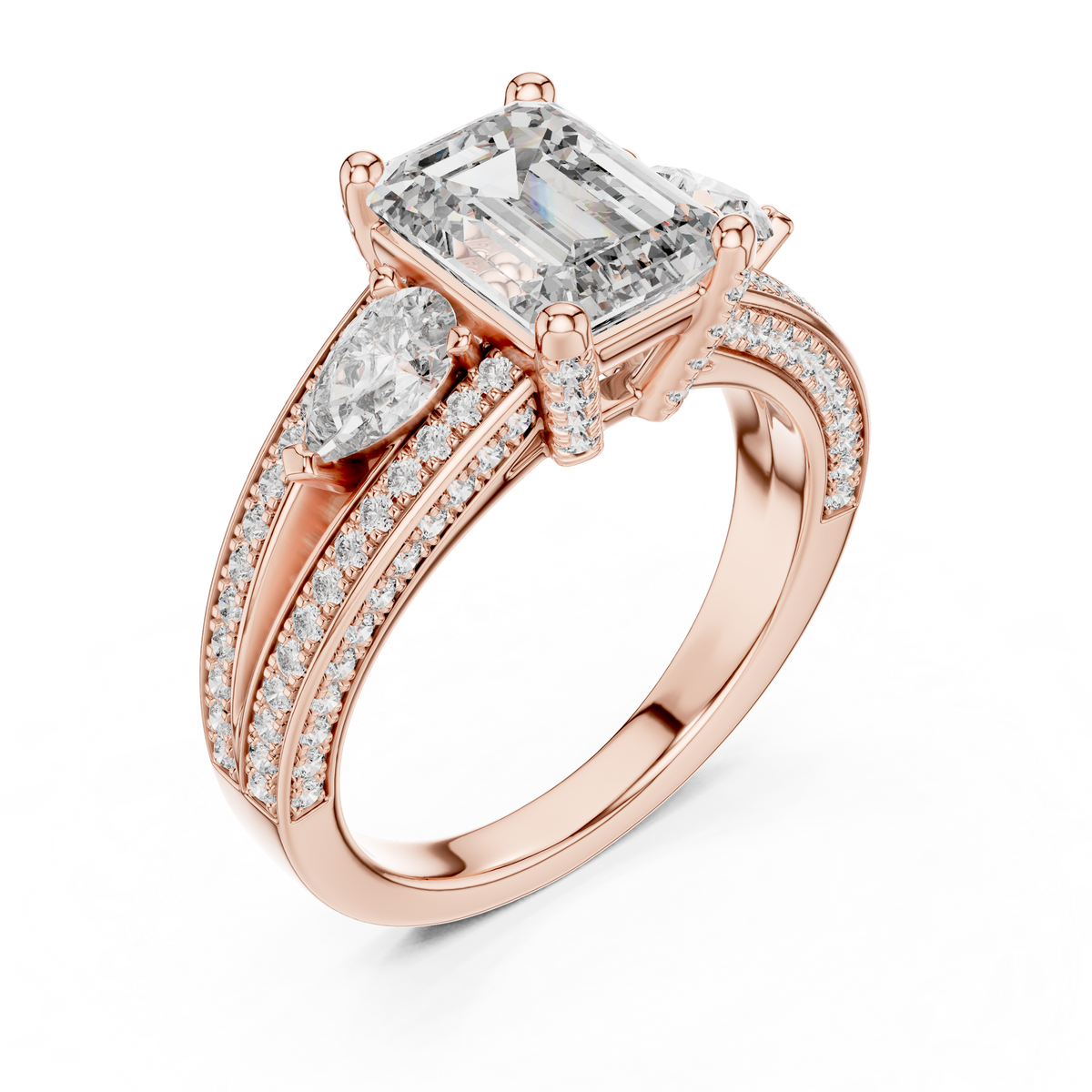 Rose gold lab grown diamond emerald and pear three stone engagement ring, angled view