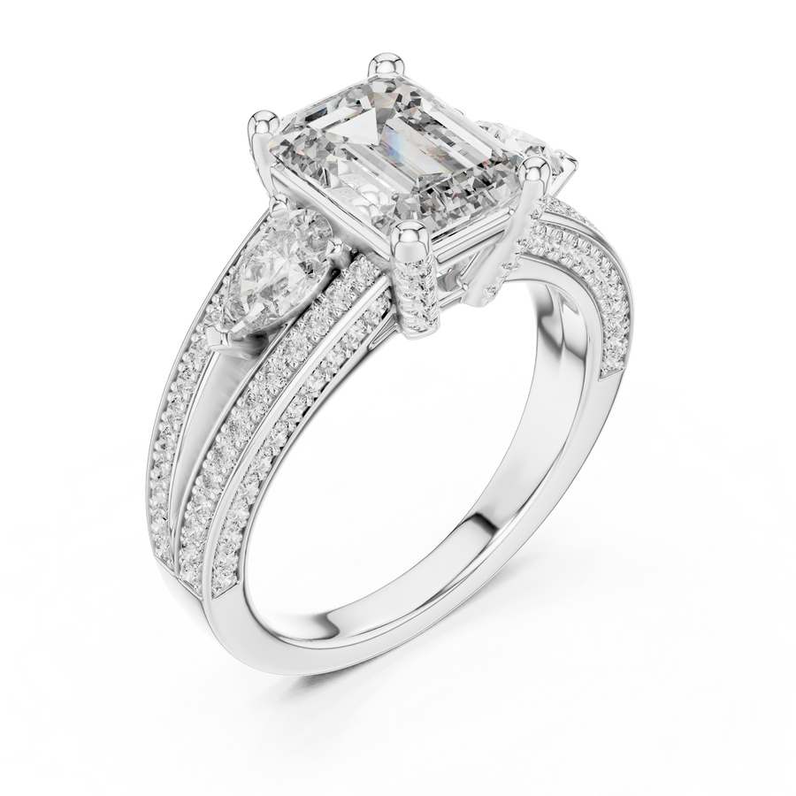 White gold lab grown diamond emerald and pear three stone engagement ring, angled view