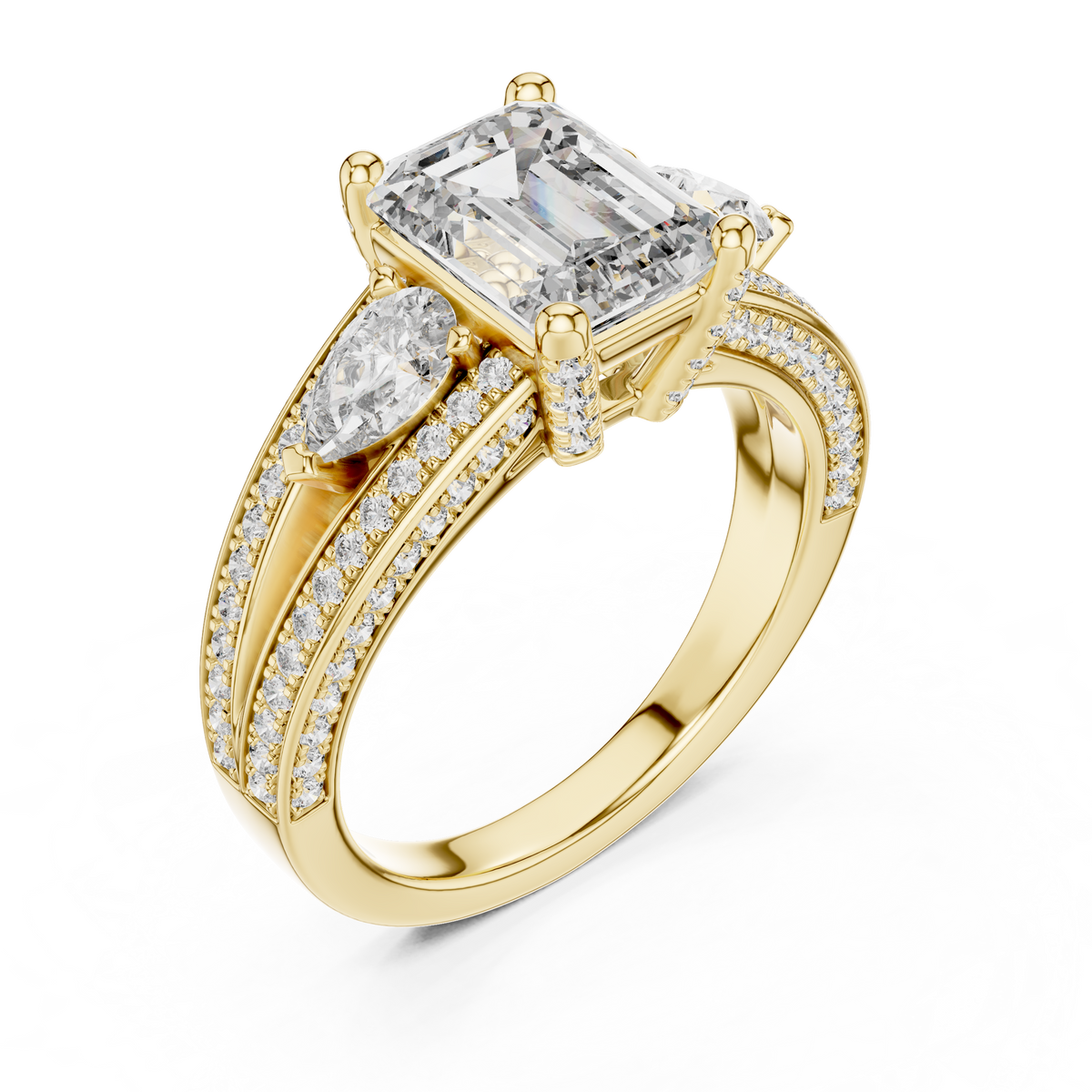 Yellow gold lab grown diamond emerald and pear three stone engagement ring, angled view