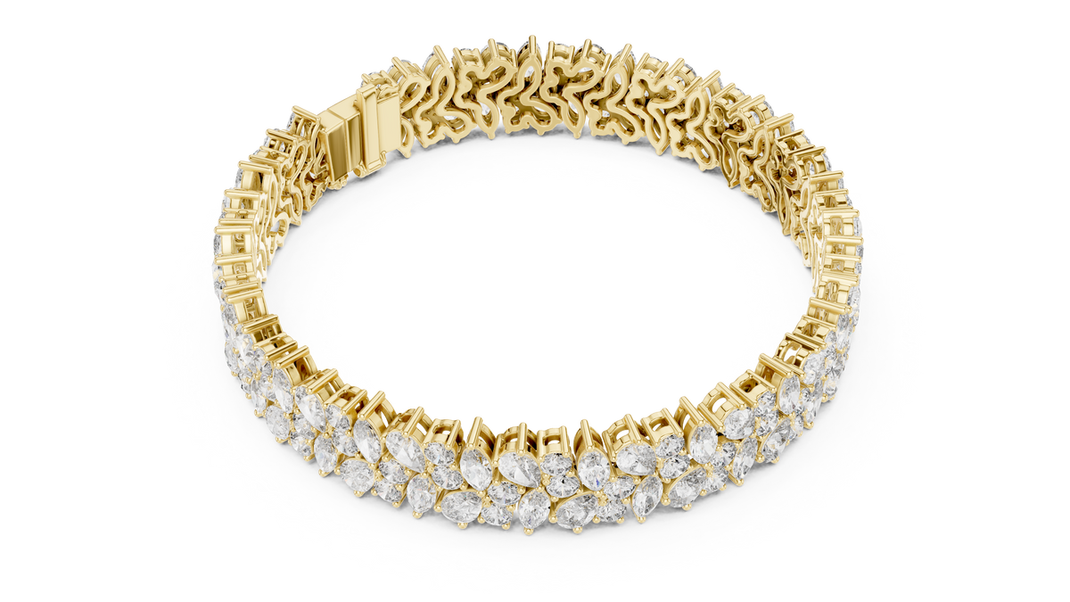 Yellow gold marquise and pear diamond cluster bracelet, angled view