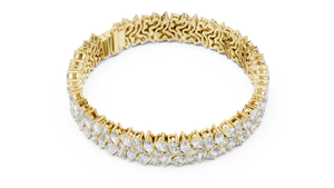 Yellow gold marquise and pear diamond cluster bracelet, angled view