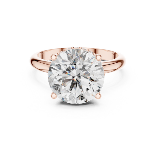 Rose gold ring with a large diamond on a white background