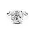 Front view of a round brilliant cut diamond solitaire engagement ring in white gold or platinum with a transparent background.