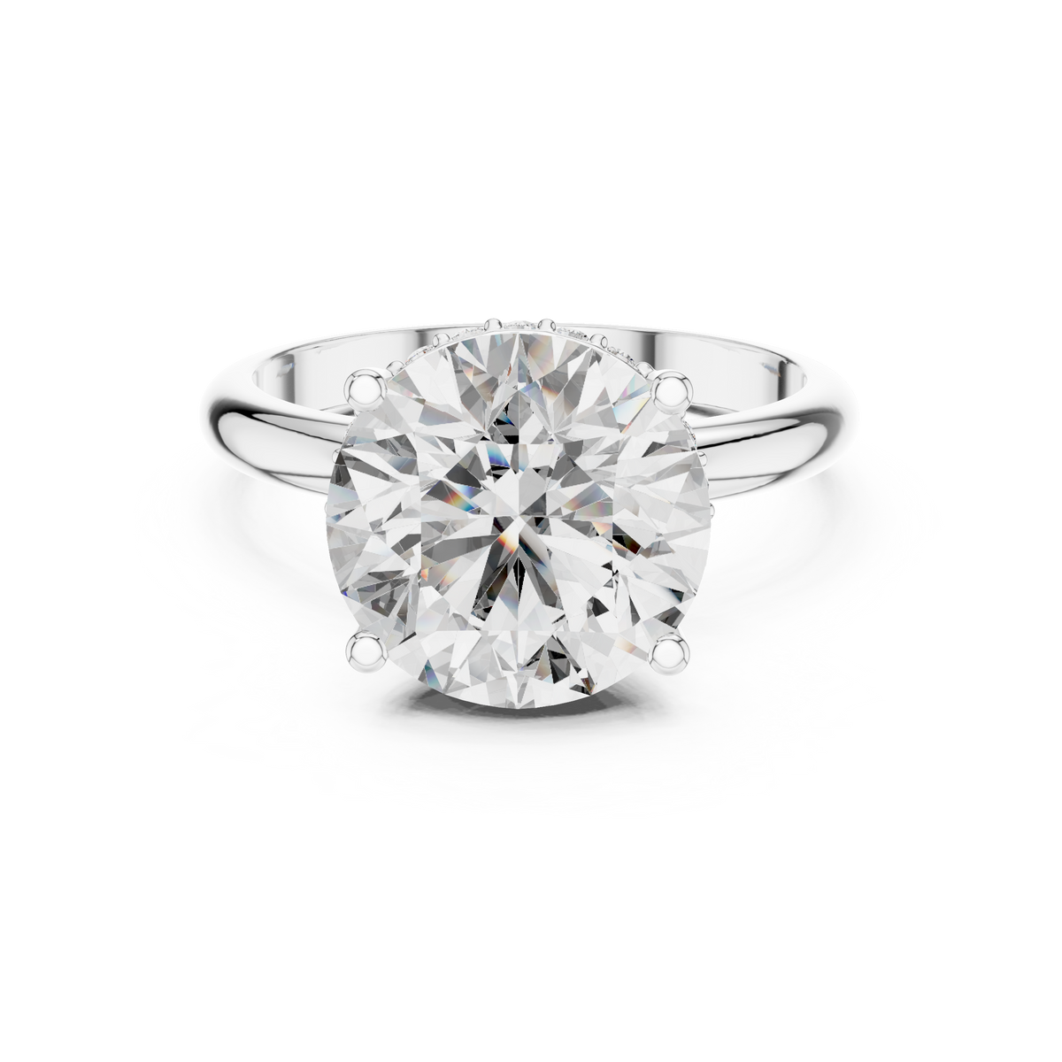 Front view of a round brilliant cut diamond solitaire engagement ring in white gold or platinum with a transparent background.