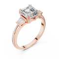 Emerald cut lab grown diamond three stone ring with baguette side stones in rose gold, front view
