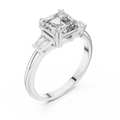 Diamond ring with a central square-cut diamond and two baguette diamonds on a white background