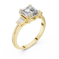 Emerald cut lab grown diamond three stone ring with baguette side stones in yellow gold, front view
