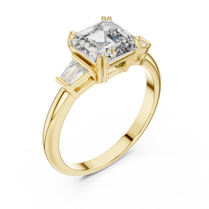 Emerald cut lab grown diamond three stone ring with baguette side stones in yellow gold, front view