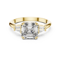 Emerald cut lab grown diamond three stone ring in yellow gold, angled view