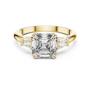 Emerald cut lab grown diamond three stone ring in yellow gold, angled view
