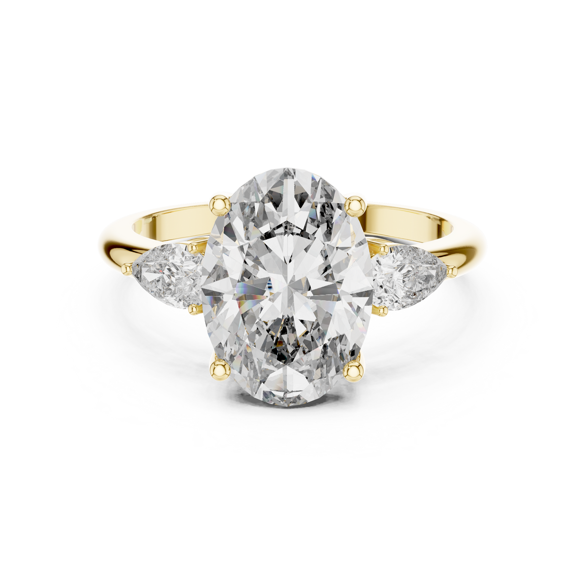 A front close-up view of a luxury three-stone lab-grown diamond engagement ring in solid yellow gold, highlighting a brilliant 2.75 carat oval center diamond and two pear-shaped side stones.
