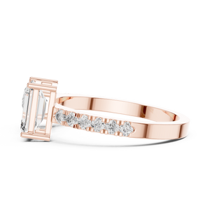 A side view of a luxury Toi et Moi lab-grown diamond engagement ring crafted in solid rose gold, showcasing the emerald-cut center diamond and brilliant pavé diamonds along the band.