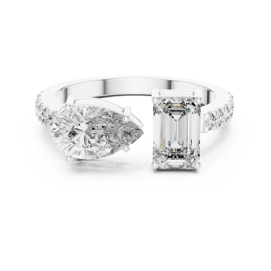 A front close-up view of a luxury Toi et Moi lab-grown diamond engagement ring in solid white gold, featuring a 0.86 carat emerald-cut diamond and a 1.00 carat pear-shaped diamond on a pavé accented open band.