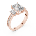 Emerald cut three stone lab grown diamond ring in rose gold, angled view