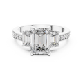 Close-up detail of white gold three-stone emerald cut diamond ring