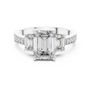 Close-up detail of white gold three-stone emerald cut diamond ring