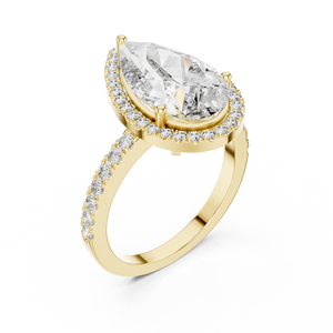Front view of a stunning pear-cut diamond halo engagement ring in yellow gold