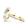 Side profile of a pear-cut diamond engagement ring in yellow gold with a hidden halo