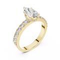 Side view of a 1.10 CT pear cut lab grown diamond engagement ring with pave band in yellow gold
