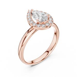 Rose gold ring with a pear-shaped diamond on a white background
