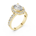 Gold ring with a large oval-cut diamond center stone, a sparkling diamond halo, and pavé-set side stones on a white background.