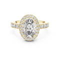 Gold ring with a large oval-cut diamond center stone, a sparkling diamond halo, and pavé-set side stones on a white background.