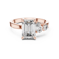 Rose gold lab grown diamond emerald cut ring with asymmetric accents, angled view — Luzora Jewels