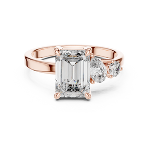 Rose gold lab grown diamond emerald cut ring with asymmetric accents, angled view — Luzora Jewels