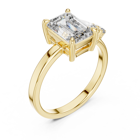 Yellow gold lab grown diamond emerald cut ring with asymmetric accents, angled view — Luzora Jewels