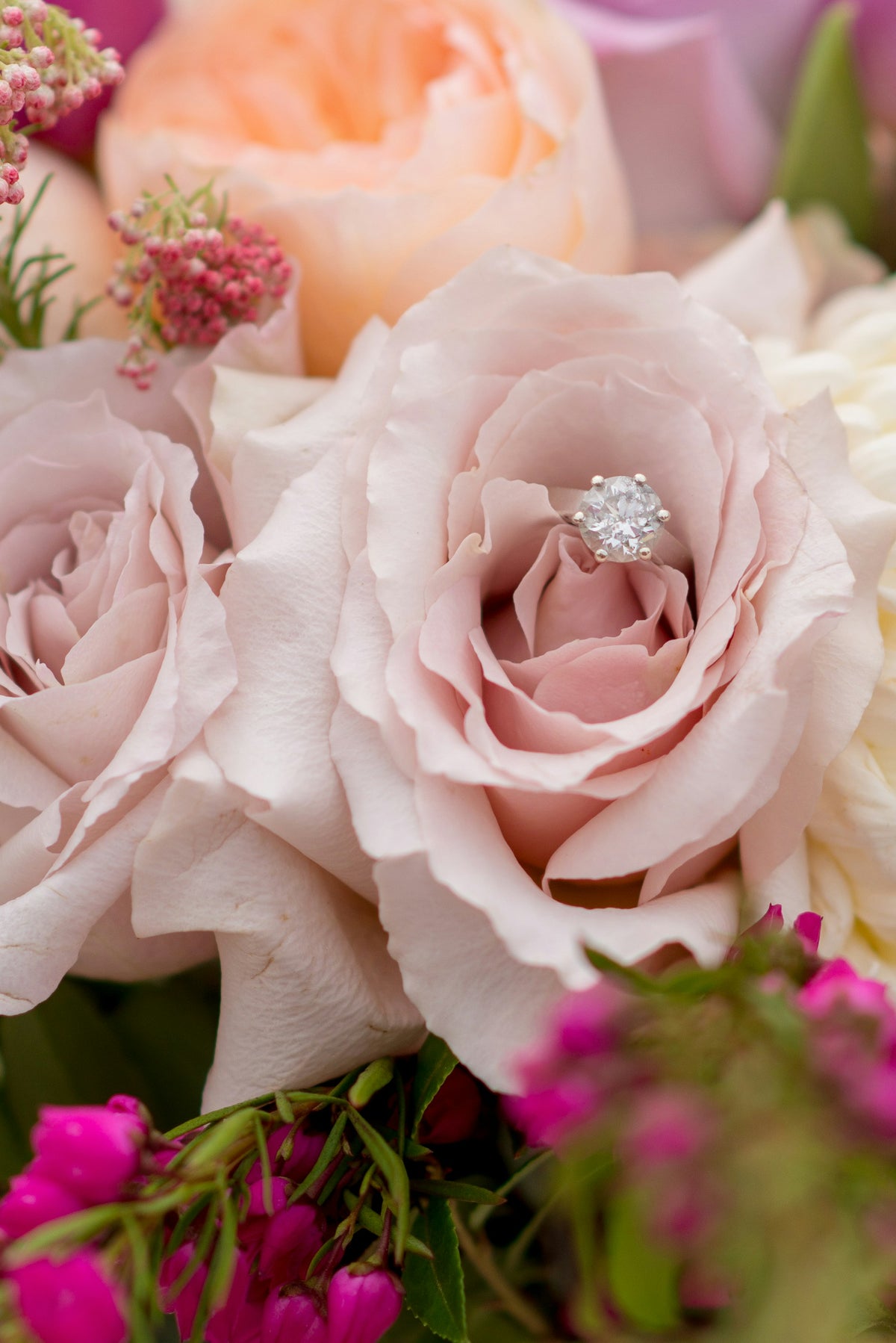 Diamond engagement ring on a bouquet of flowers