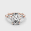 A stunning three-stone lab-grown diamond engagement ring in 14k rose gold, featuring a massive 2.75 carat oval-cut center diamond flanked by two brilliant pear-cut side stones on a clean white background.