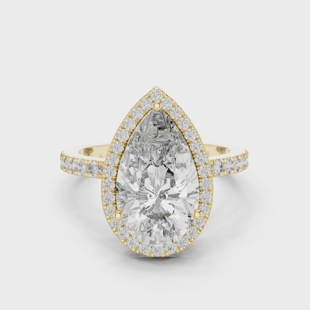 360-degree view of a pear-cut diamond halo engagement ring in yellow gold