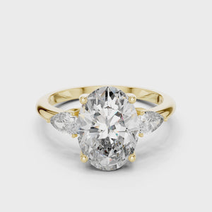 A video showcasing a luxury three-stone lab-grown diamond engagement ring in solid yellow gold, highlighting a brilliant 2.75 carat oval center diamond paired with two pear-cut side stones.
