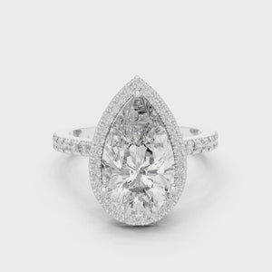 360-degree view of a pear-cut diamond halo engagement ring in white gold